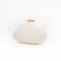Acrylic shell clutch evening bag, white marble texture with gold clasp detail close-up. - White