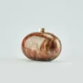 Detail view of brown marble pattern oval acrylic evening clutch bag with gold metal clasp. - Coffee