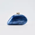 Detailed view of the blue marble acrylic clutch purse with gold sphere clasp for evening parties. - Blue