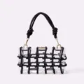 Clear acrylic box handbag with black knotted rope grid design and gold hardware detail. - Black