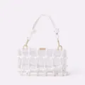 Transparent acrylic box handbag detail with white woven rope knot and gold hardware. - White