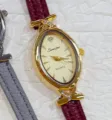 Sunlifex elegant women oval quartz watch featuring maroon leather strap for daily casual wear. - Gold Case Gold Dial Red Strap