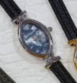 Exquisite small oval women quartz watch with black leather strap and sparkling rhinestone bezel. - Silver Case Blue Dial Black Strap