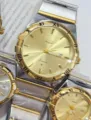Gold quartz couple watch with Roman numerals and metal strap. Fashionable design for daily wear. - Two-Tone Gold Gold Dial Men
