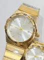 Gold quartz couple watch with Roman numerals dial and metal wave link bracelet for daily wear - All Gold White Dial Men