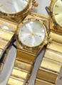 Golden quartz watch featuring metal strap, Roman numerals and clear calendar window. - All Gold White Dial Women