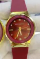 Red quartz watch with gold bezel, silicone strap, and elegant rhinestone dial markers. - Red Dial Red Strap (Women)