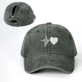 Detail view of distressed gray ponytail baseball cap featuring white heart beat print. - Adjustable / Army Green
