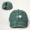 Detailed view of distressed green ponytail baseball cap with heart heartbeat print and back strap. - Adjustable / Dark Green