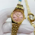 Gold stainless steel quartz watch pink dial detailed view with calendar display close up. - All Gold Pink Dial Women