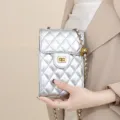 Silver quilted phone bag detail, classic diamond pattern with luxury metal chain and twist lock. - Silver