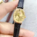 Montre quartz pour femme élégante avec cadran doré ovale et bracelet en cuir noir, chic. - Boîtier Doré Cadran Doré Bracelet Noir
