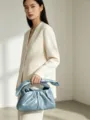 Detailed view of the metallic blue knotted clutch handbag showcasing exquisite craftsmanship. - 23CM*7CM*12.5CM / Sky Blue