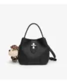 Black leather bucket handbag detail, metal lock closure, cute plush dog charm accent. - Black