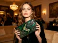 Detailed view of the vintage green embossed leather wallet with intricate deer motif. - Green