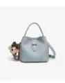 Light blue bucket bag detail showing soft leather texture, metal lock and cute bear pendant. - Blue Gray