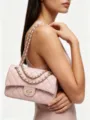 Detailed view of the elegant pink quilted chain shoulder bag worn on shoulder, chic and stylish. - 26CM*7CM*17CM / Pink