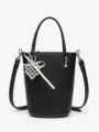 Black pebbled leather bucket bag with top handle, crossbody strap and cute heart charm. - Black