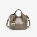 Detailed view of a chic taupe leather bucket bag with a cute mini pouch charm and chain. - 24CM*11CM*20CM / Khaki