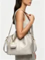 Detail view of leather hobo bucket shoulder bag with mini charm accessory, elegant and stylish design. - 24CM*11CM*20CM / Modilan Gray