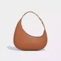 Brown crescent hobo shoulder bag with textured leather detail and metal buckle hardware. - Yellow Brown