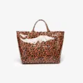 Detailed view of the glossy leopard print tote bag showing the waterproof finish and dual top handles. - Leopard Print Orange