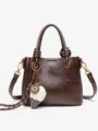 Retro brown PU leather handbag for women, elegant shoulder bag with stylish charm pendant. - Coffee