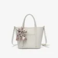 Elegant white leather tote bag with stylish checkered bow scarf, versatile crossbody handbag for women. - Off White