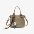 Elegant grey bucket handbag with top handle, chic knot details and cute charm pendant. - Khaki