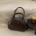 Stylish brown patent leather bowling bag for women, chic top-handle crossbody handbag. - Coffee