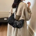 Black crocodile pattern motorcycle shoulder bag with metal buckles and rivets for women commuting fashion. - Black