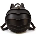 Close-up detail showing the unique shell-like layered flap design of the leather backpack. - Dark Brown