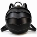 Detail view of the unique beetle shell shaped genuine leather backpack in sleek black color. - Oil Skin Black
