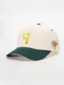 Stylish two-tone baseball cap with embroidered front detail and side graphic patch for outdoor wear. - Adjustable / Cream/Dark Green
