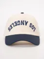Detailed view of the stylish color-block baseball cap with embroidered lettering design. - Adjustable / Cream/Navy Blue