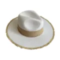Detailed view of the stylish two-tone straw hat, featuring a woven brim and classic fedora crown. - White