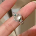 French vintage palace style oval gemstone ring with crystal pavé and green side stones detail - Size 6 / White Gold
