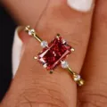 Primer plano detallado de un anillo de circonita roja brillante con piedras laterales. - Talla 5 / Rojo