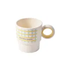 Simple plastic mouthwash cup featuring a unique ring handle and cute dot pattern for daily use. - Yellow