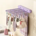 Wall-mounted folding drying rack with multiple clips, space-saving pink-purple laundry organizer. - Peach Pink