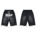 Detailed view of black washed denim shorts with rhinestone Valley letters and raw hem. - S / Black