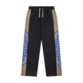 Detailed view of the streetwear colorblock sweatpants, highlighting the gothic side print. - S / Black With Blue Letters