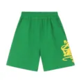 Casual green streetwear shorts with yellow graffiti letter print, comfortable elastic waist. - S / Bottoms / Green