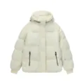 Detailed view of the white hooded puffer jacket, showcasing the zipper pocket and fabric texture. - L / Apricot