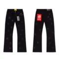 Detailed view of black straight denim jeans with allover embroidered gothic letters and split hem. - XL=34 / Washed Black