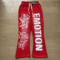 Red casual pants featuring cupid graphic print and bold emotion typography detail. - S / Bottoms / Red