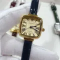 Square quartz women's watch with elegant Roman numerals and a stylish dark blue leather strap. - Gold Case Gold Dial Blue Strap