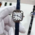 Close-up detail of square quartz watch with white Roman dial and blue leather strap. - Silver Case White Dial Blue Strap