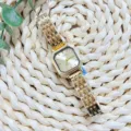 Detail shot of the vintage gold square quartz watch with exquisite metal steel strap. - Gold Gold Dial