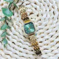 Elegant women gold quartz watch with green octagonal dial steel strap detail view - Gold Green Dial